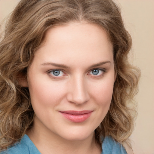 Joyful white young-adult female with long  brown hair and green eyes