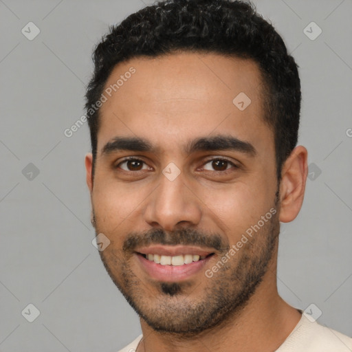 Joyful latino young-adult male with short  black hair and brown eyes