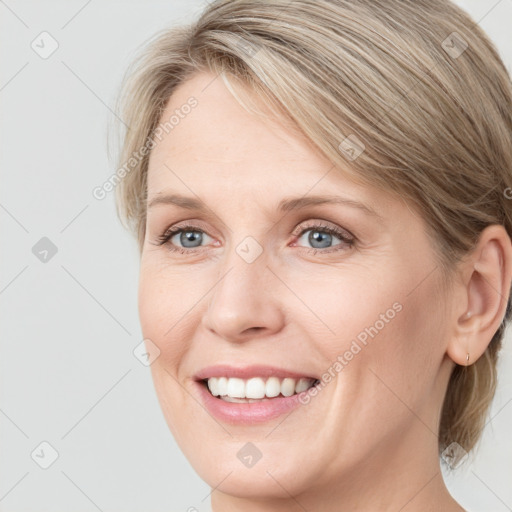 Joyful white young-adult female with medium  brown hair and blue eyes