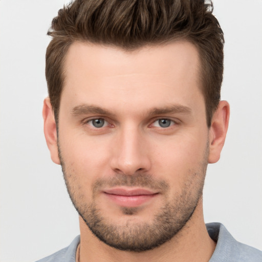 Joyful white young-adult male with short  brown hair and brown eyes