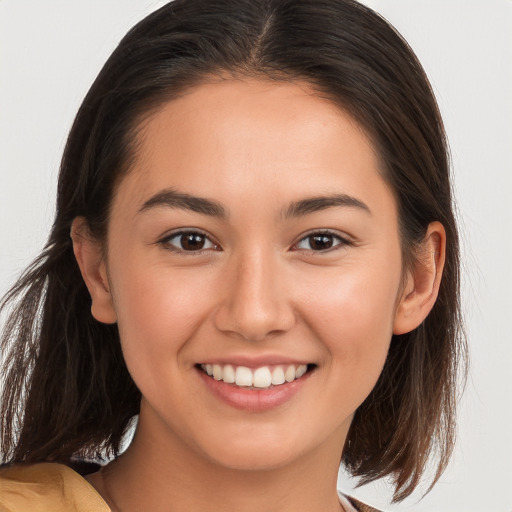 Joyful white young-adult female with long  brown hair and brown eyes