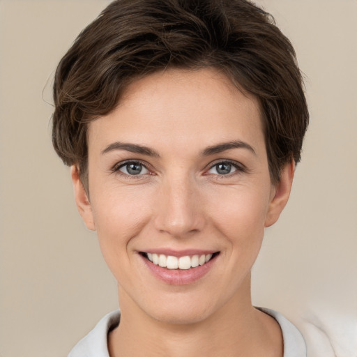 Joyful white young-adult female with short  brown hair and brown eyes