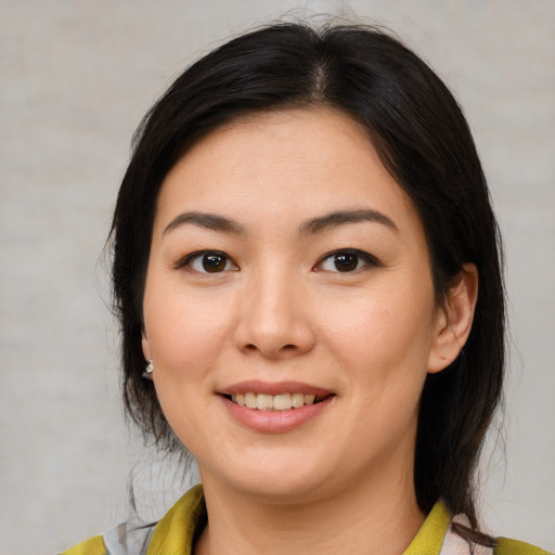 Joyful white young-adult female with medium  brown hair and brown eyes