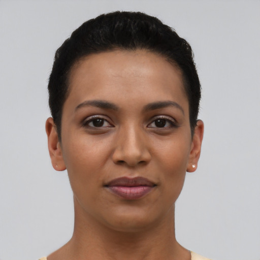Joyful latino young-adult female with short  black hair and brown eyes