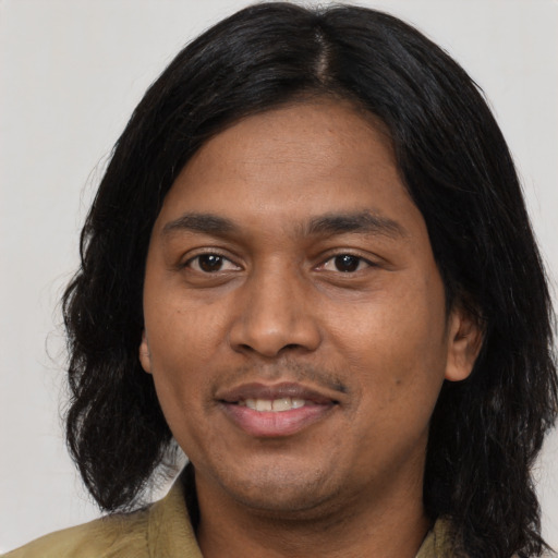 Joyful asian young-adult male with long  black hair and brown eyes