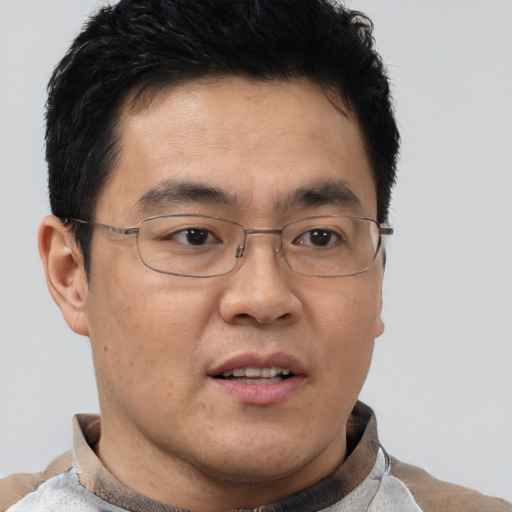 Joyful latino adult male with short  brown hair and brown eyes