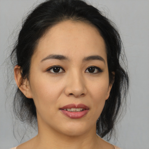 Joyful asian young-adult female with medium  brown hair and brown eyes