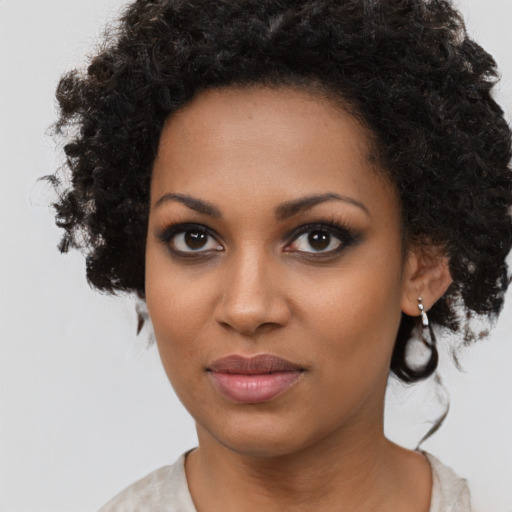 Neutral black young-adult female with medium  brown hair and brown eyes