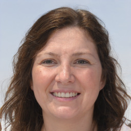 Joyful white adult female with long  brown hair and grey eyes