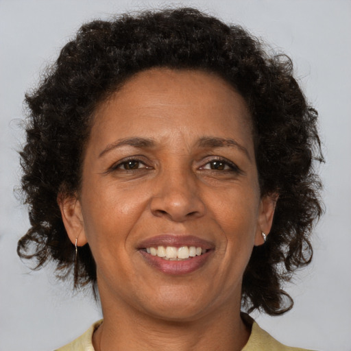 Joyful black adult female with short  brown hair and brown eyes