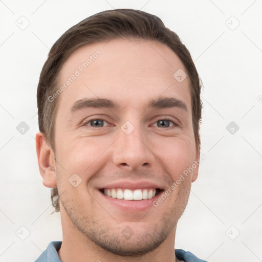 Joyful white young-adult male with short  brown hair and grey eyes