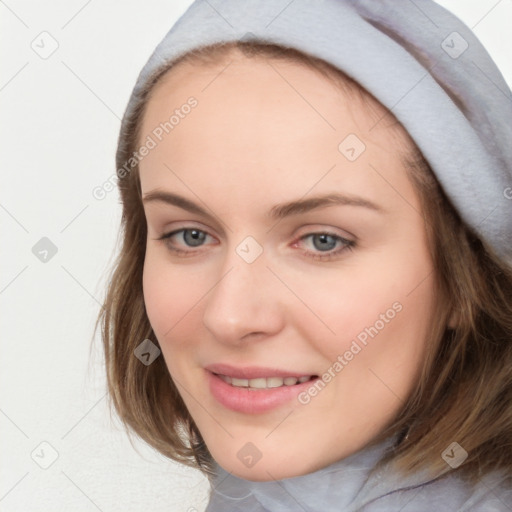 Joyful white young-adult female with medium  brown hair and blue eyes