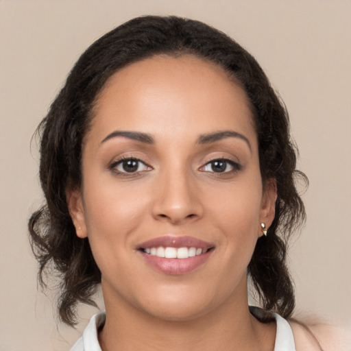 Joyful latino young-adult female with medium  brown hair and brown eyes