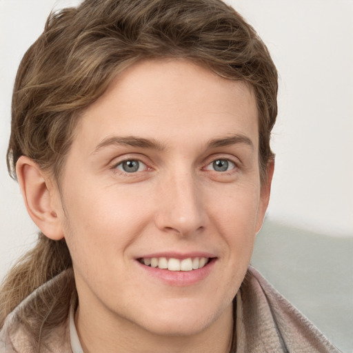 Joyful white young-adult female with short  brown hair and grey eyes