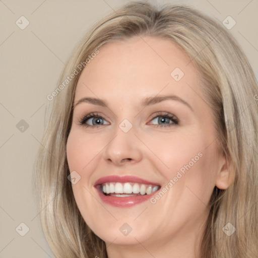 Joyful white young-adult female with long  brown hair and blue eyes