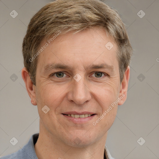 Joyful white adult male with short  brown hair and grey eyes