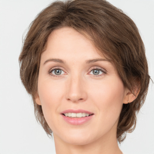 Joyful white young-adult female with medium  brown hair and green eyes