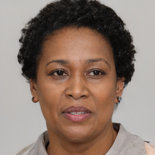 Joyful latino adult female with short  brown hair and brown eyes
