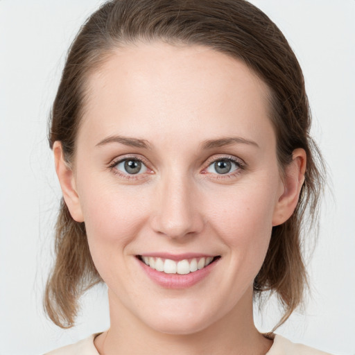 Joyful white young-adult female with medium  brown hair and blue eyes