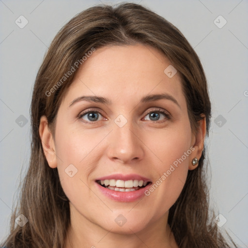 Joyful white young-adult female with long  brown hair and grey eyes