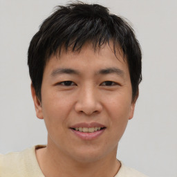 Joyful asian young-adult male with short  brown hair and brown eyes