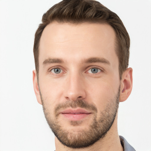 Joyful white young-adult male with short  brown hair and grey eyes