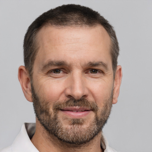 Joyful white adult male with short  brown hair and brown eyes