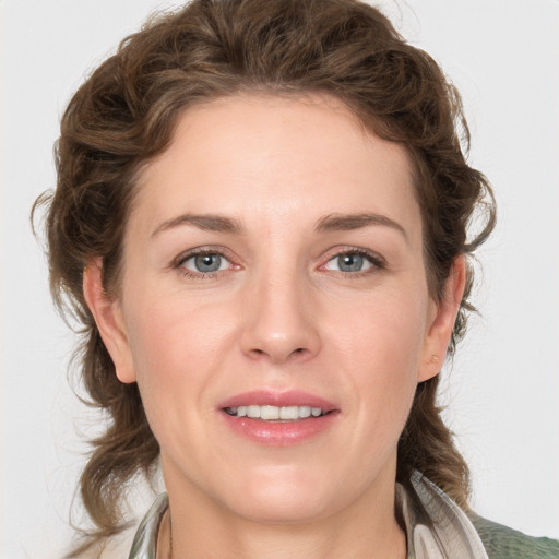 Joyful white young-adult female with medium  brown hair and grey eyes