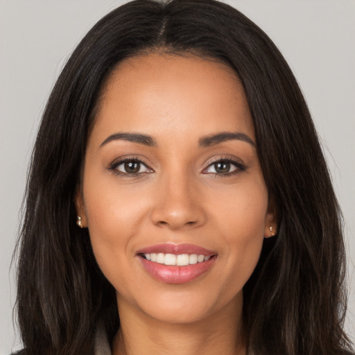 Joyful white young-adult female with long  brown hair and brown eyes