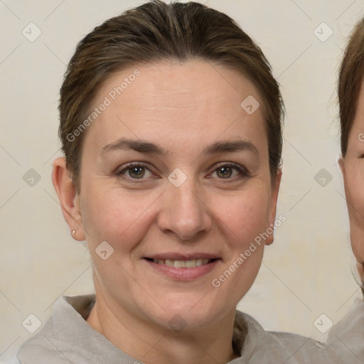 Joyful white adult female with short  brown hair and brown eyes