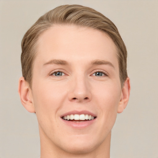 Joyful white young-adult male with short  brown hair and grey eyes