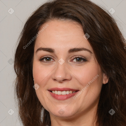 Joyful white adult female with long  brown hair and brown eyes