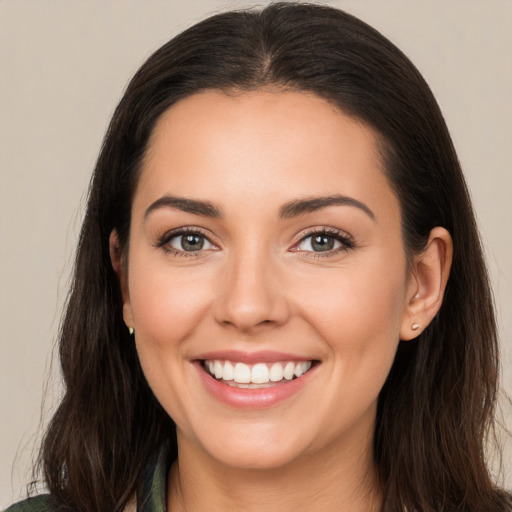 Joyful white young-adult female with long  brown hair and brown eyes