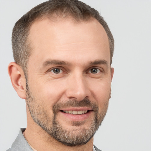 Joyful white adult male with short  brown hair and brown eyes