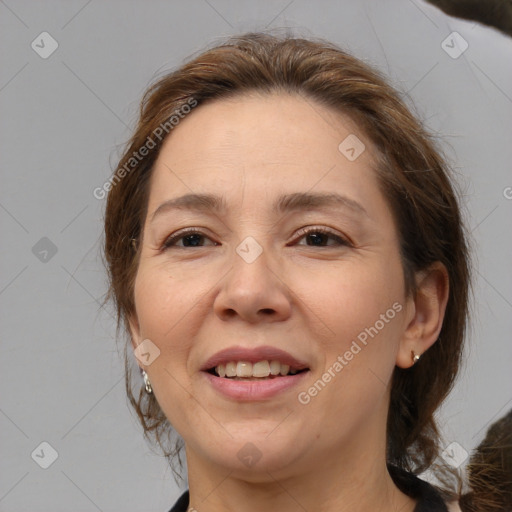 Joyful white adult female with medium  brown hair and brown eyes