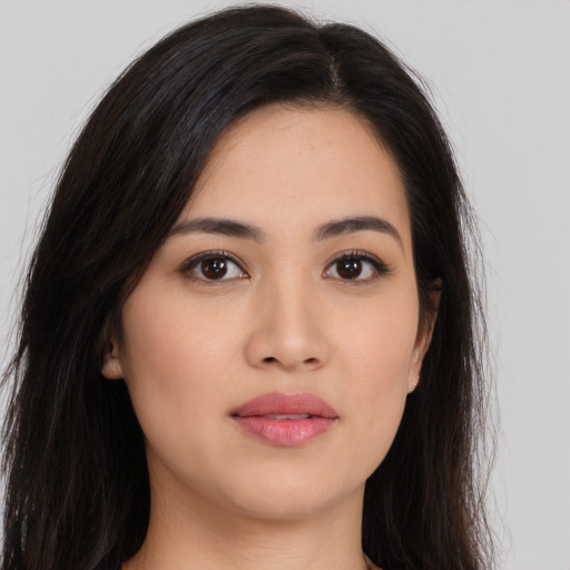 Joyful asian young-adult female with long  brown hair and brown eyes