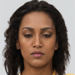 Neutral black young-adult female with long  brown hair and brown eyes