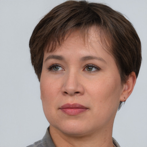 Joyful asian adult female with short  brown hair and grey eyes