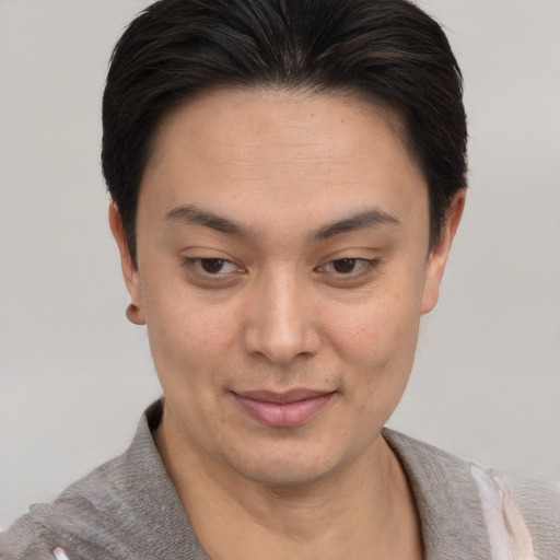 Joyful asian young-adult female with short  brown hair and brown eyes