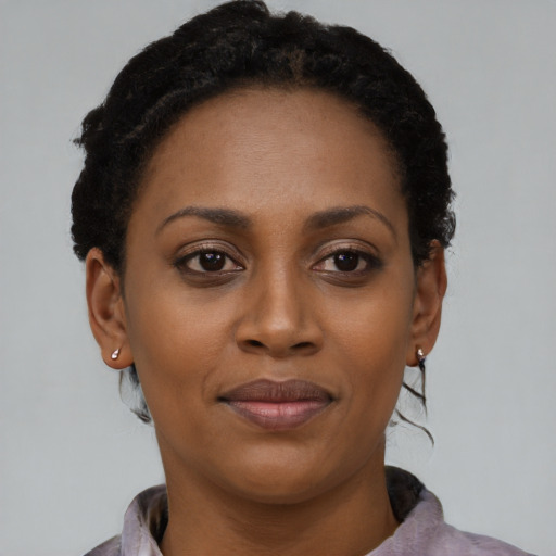 Joyful black adult female with short  brown hair and brown eyes