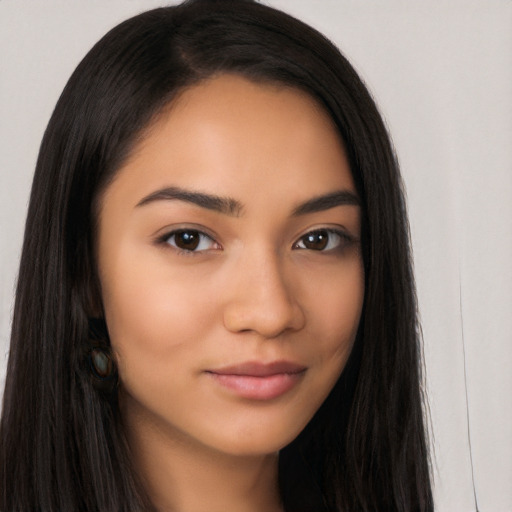 Joyful latino young-adult female with long  brown hair and brown eyes