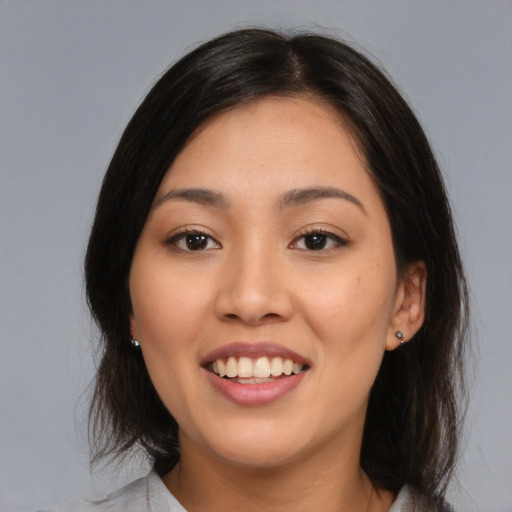 Joyful white young-adult female with medium  brown hair and brown eyes