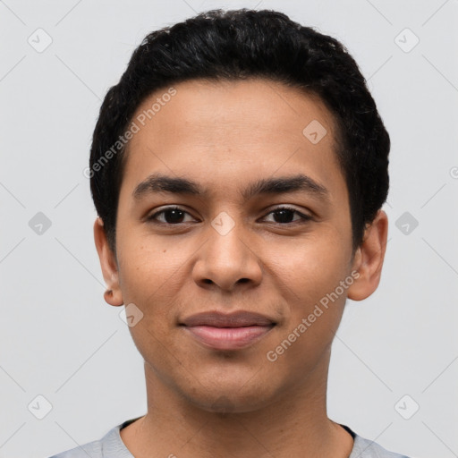 Joyful latino young-adult male with short  black hair and brown eyes