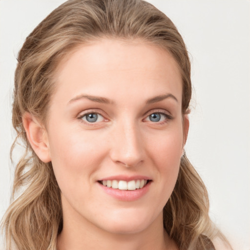 Joyful white young-adult female with long  brown hair and blue eyes