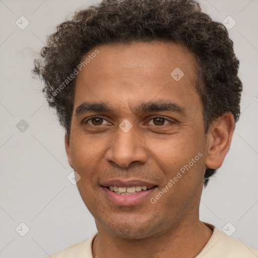 Joyful latino young-adult male with short  brown hair and brown eyes