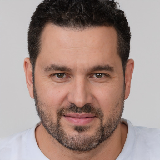 Joyful white adult male with short  brown hair and brown eyes