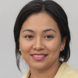 Joyful asian young-adult female with medium  brown hair and brown eyes