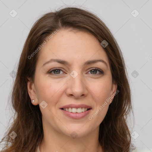 Joyful white adult female with long  brown hair and grey eyes