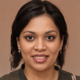 Joyful latino young-adult female with medium  brown hair and brown eyes