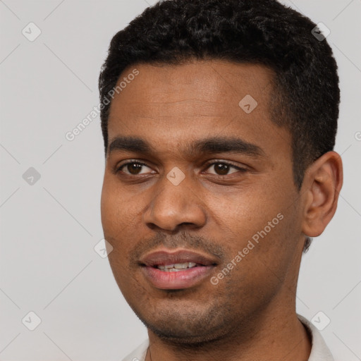 Joyful black young-adult male with short  black hair and brown eyes